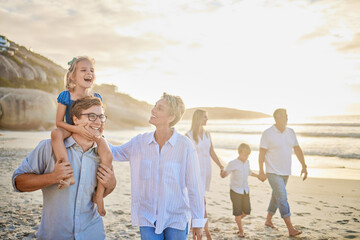 Family, beach and walking with fun, parents and kids together with grandparents outdoor. Sunset,...