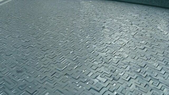 Closeup of textured surface with intricate maze patterns in a modern urban setting