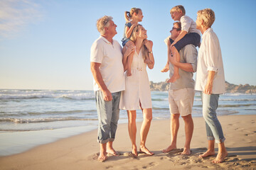 Obraz premium Generations, family and laughing at beach on portrait for bonding, care and love in Mauritius. Outdoor, people and happy with support at seaside on holiday, journey and travel for memories and fun