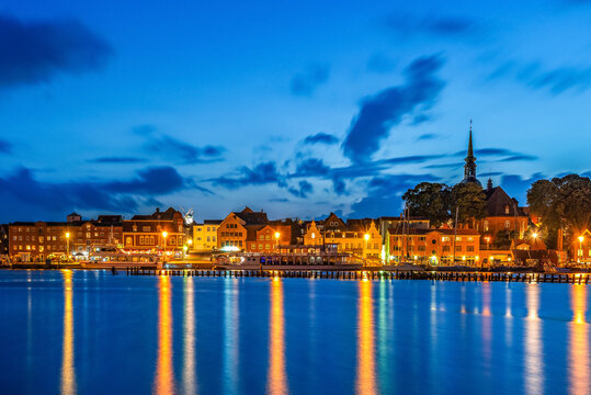 View to the skyline of small city of Kappeln in Germany at blue hour