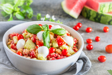 Couscous salad with tomatoes, cucumber, water melon, mozzarella, basil