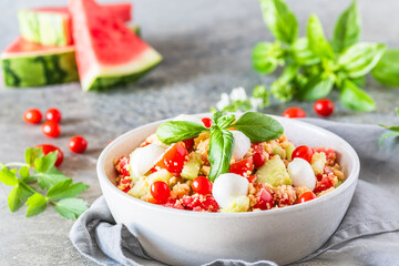 Couscous salad with tomatoes, cucumber, water melon, mozzarella, basil