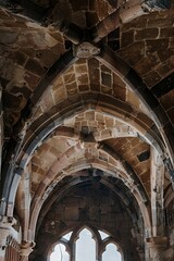 Fototapeta premium Intricate stone arches and ceiling details in a historic architectural setting.