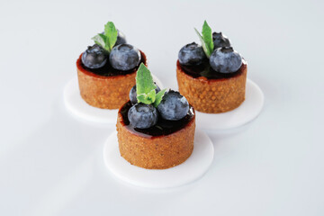 Made by professional baker. Delicious tart with blueberries against white background