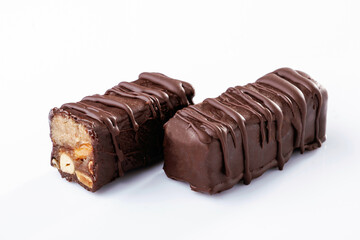 Chocolate bars lie on a white surface, isolated