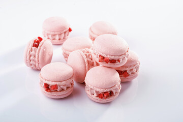 Pink colored. Bunch of macarons on the white surface