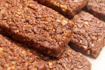 Nutritious protein chocolate bars from wholesome ingredients for a healthy snack on the go. Macro shot. 