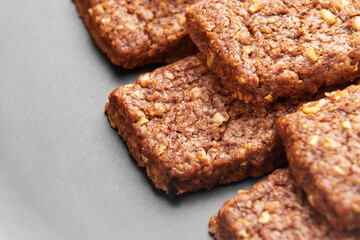 Organic chocolate oat bars on a ceramic grey plate. Healthy treats. Macro shot. 