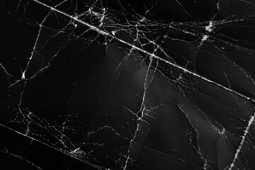 Black rough paper grunge texture with old grungy cracks and ragged wrinkles. Aged abstract design background