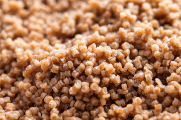Cooked steamed buckwheat couscous grains. Healthy nutritious gluten free cuisine. Brown texture. 