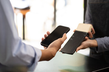 Woman use smartphone to scan QR code to pay in cafe restaurant with a digital payment without cash. Choose menu and order accumulate discount. E wallet, technology, pay online, credit card, bank app.
