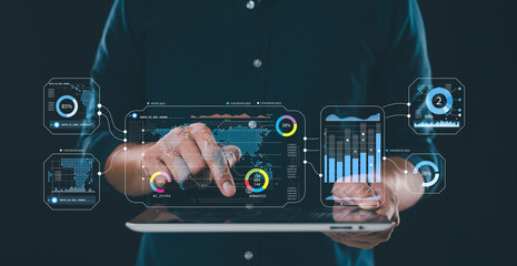 businessman is using a digital tablet to analyze and calculate financial data, focusing on economic growth charts. This involves strategic business planning, market research, and decision making.