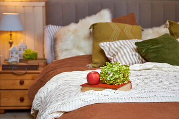 Modern bedroom interior, double bed with beige linen bedspread and colorful pillows