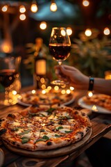 Enjoying gourmet pizza and red wine in a cozy outdoor setting with twinkling lights during an evening gathering