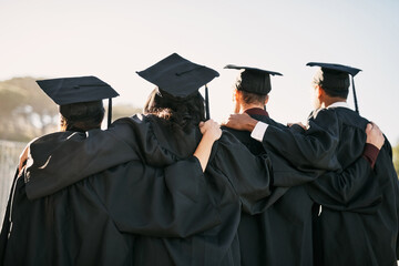 Facing a world of new possibilities. Rearview shot of a group of students standing together on...