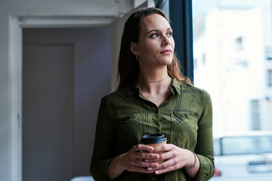 Woman, coffee cup and thinking in office, planning and window for career reflection or latte. Female person, espresso and morning inspiration for job in workplace, tea break and employee for memory