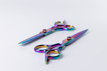 Two scissors centrally placed on a plain white background.