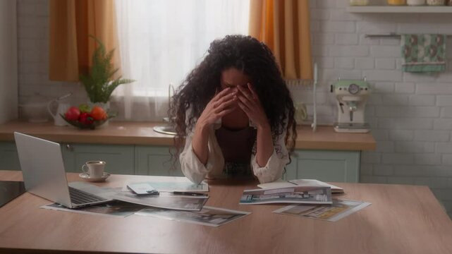 Tired stressed Hispanic woman girl Latina female Caucasian lady homeowner at home kitchen with laptop looking mobile phone failure problem loose pictures photos design templates renovation interior