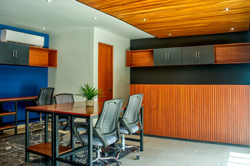 Modern office with wood finishing and blue accent walls