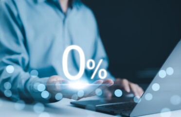 Zero Percent Interest Rate. Businessman holds glowing 0 percent symbol in his hand, symbolizing...