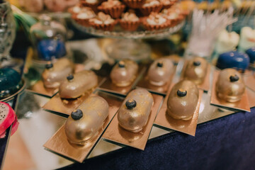 A table with a variety of desserts, including cakes and pastries, arranged in a visually appealing...