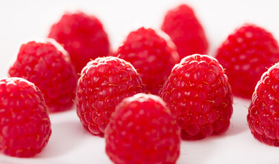 Handful of raspberry berries on white background