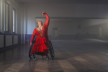 Beautiful dance in a wheelchair of a woman with disability at a dancing studio. Para dance sport.
