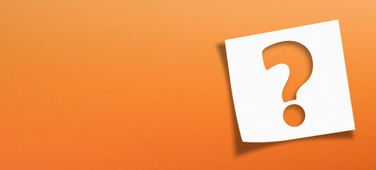 Note paper with question mark on orange background