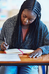 Black woman, student and writing notes at university for learning, study and education. College,...