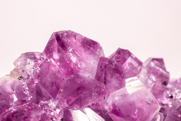 Fototapeta premium Amethyst pink crystals. Gems. Mineral crystals in the natural environment. Texture of precious and semiprecious stones. Seamless background with copy space colored shiny surface of precious stones.