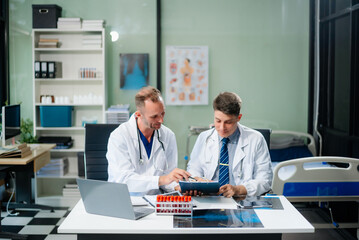 Fototapeta premium Diverse team of doctors and specialists brainstorming with digital tools, discussing test results and planning in hospital