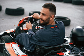 Extreme sports, driving. Man is outdoors, kart racing conception