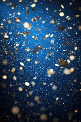 Sparkling Gold and White Confetti Falling Against a Vibrant Blue Background
