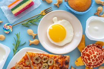 Breakfast ideas for kids. Sunny side up egg in the form of apple on the table with tasty and healthy food for kid's breakfast..