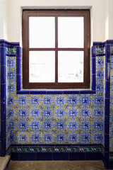 Wooden window on vintage tiled wall in Madrid