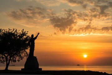Hispanic Heritage Monument: A photograph of a monument or statue commemorating Hispanic contributions to society, set against a sunset backdrop. 