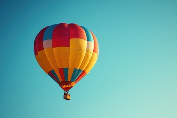 Obraz premium A colorful hot air balloon floating against a clear blue sky
