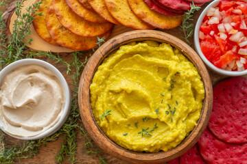 Avocado creamy dip served with salsa salad, tahini pasta, beetroot and carrot cookies.