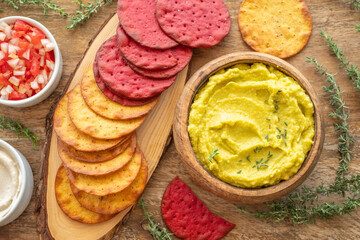 Snack board with beetroot and batata cookies, salsa salad, creamy avocado dip fresh thyme.