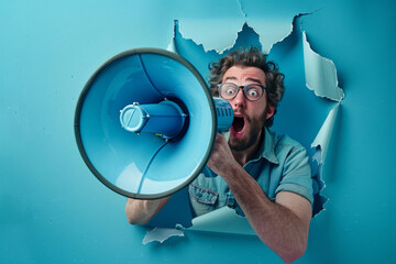 Man making important announcement speaking on megaphone through torn paper hole