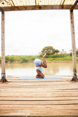 A beautiful young black woman practicing yoga outdoors in the countryside