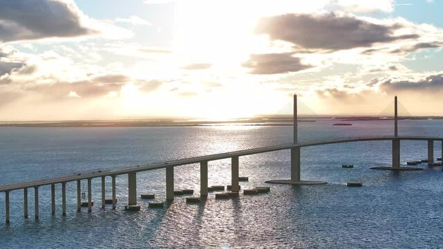 Aerial view of the skyway bridge over Tampa Bay at sunset with beautiful reflections on the water, St Petersburg, United States.
