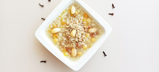 Ashura or Ashura dessert made with legumes and dried fruits on a white background