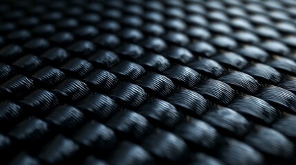 Fototapeta premium A high-resolution close-up of black carbon fiber weave texture,