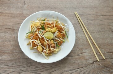 Pad Thai stir fried rice noodles with egg and bean sprout couple garlic chive on plate  