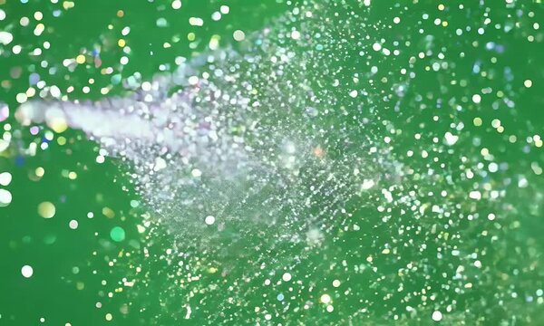 Close-up of glitter sparkle animation on a green screen, with shimmering and sparkling particles.