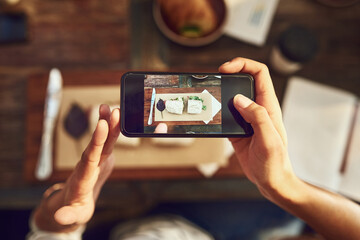 Restaurant, food and hands with phone screen for picture, photography and document experience of culinary. Above, person and mobile app with camera for sandwich, dish review and post for social media
