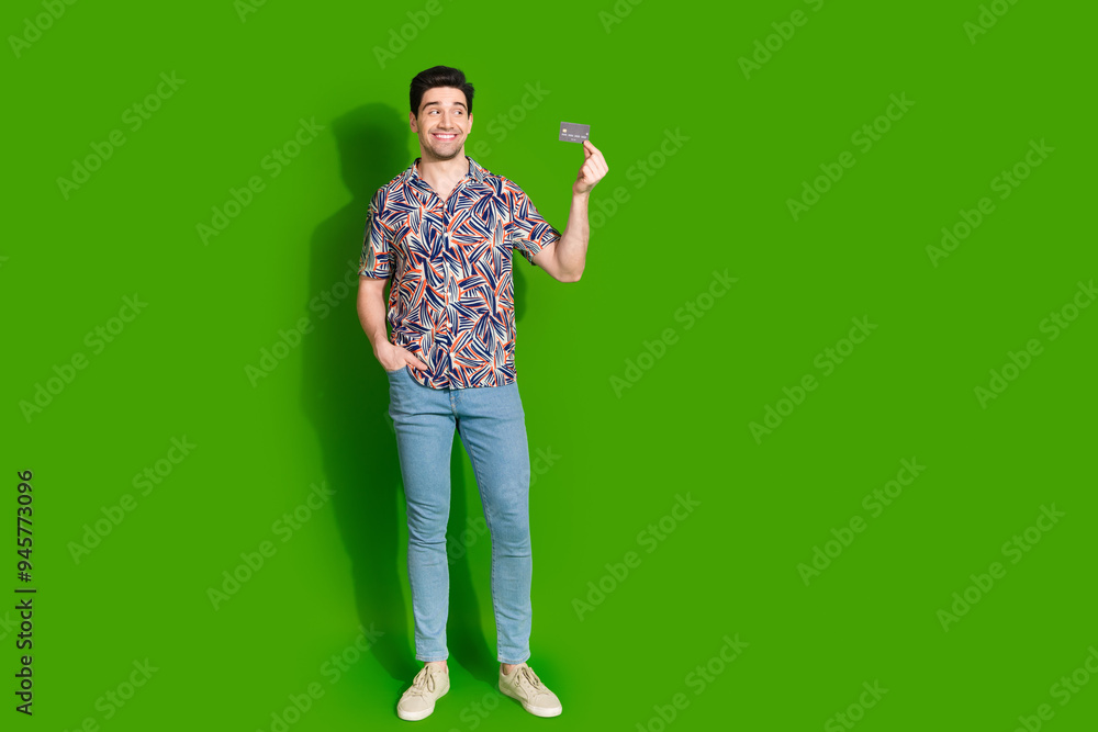 Poster full size photo of nice guy dressed print shirt jeans demonstrate credit card look empty space isola