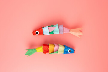 Creative craft made from an empty recycled egg box cardboard, featuring two colorful fish with...