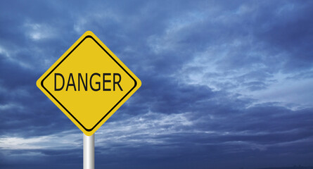 Naklejka premium danger,Hurricane Idalia warning sign against a powerful stormy background with copy space. Dirty and angled sign with cyclonic winds add to the drama.hurricane season sign on cloudy background